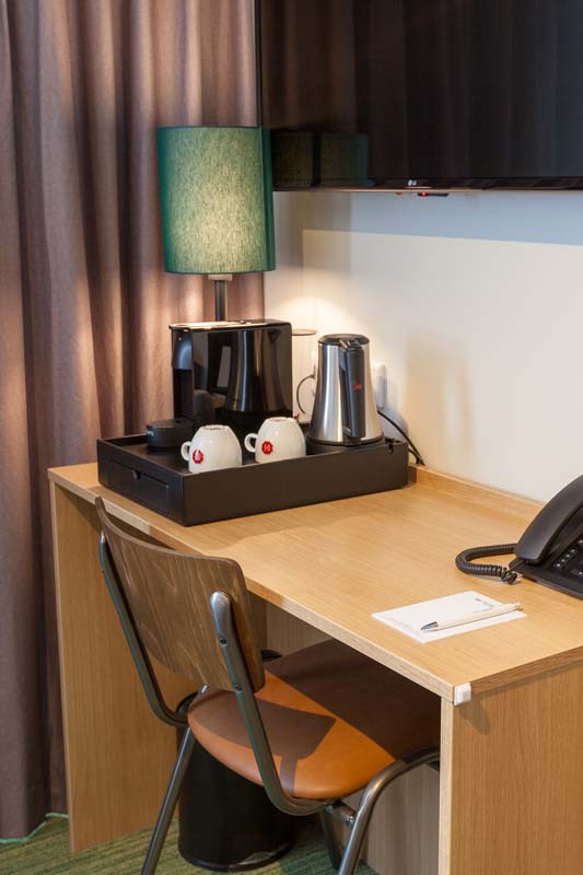 Comfortable hotel room with desk